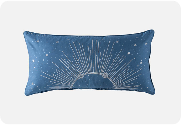 Our Supernova Boudoir Cushion Cover features a celestial silver design on rich blue fabric