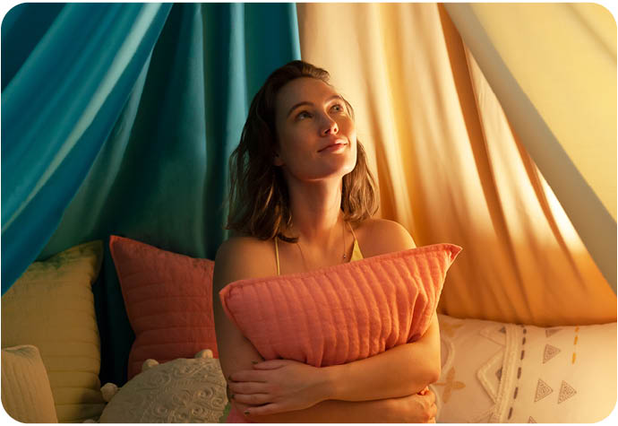 Our model Kate sits in our blanket fort with our new Linen Cotton Euro Sham in Fuschia 