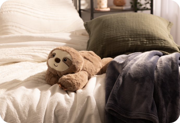 Ace Dorm Coziness Cozy dorm accessories in bed.