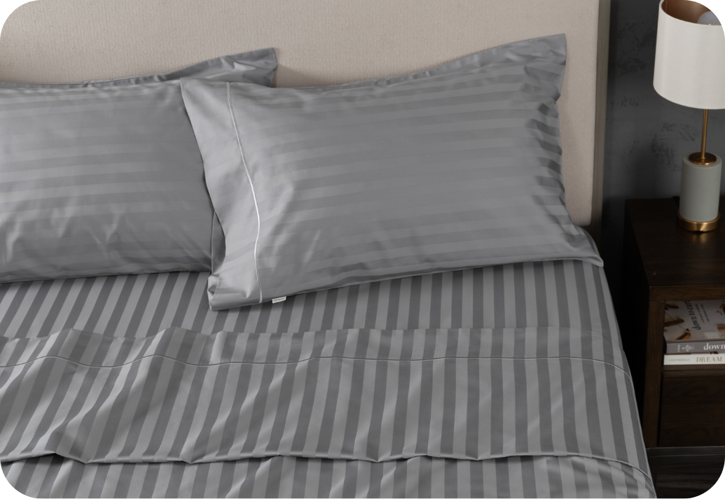 A bed dressed in grey Egyptian Cotton sheets.
