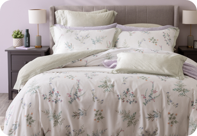 Our Annika collection dressing a queen bed with purple accessories.