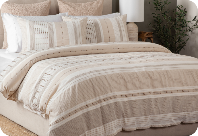 Our Adrift Duvet Cover with white sheets and accessories.