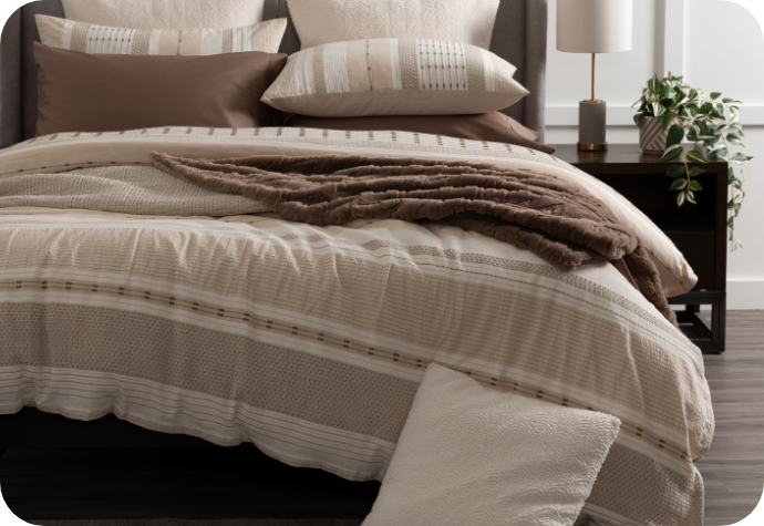 Our Adrift Duvet Cover with brown accessories and Mocha Whip Sheets.