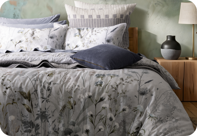 Front, off-centre view of our Greydon Duvet Cover dressing a queen bed.