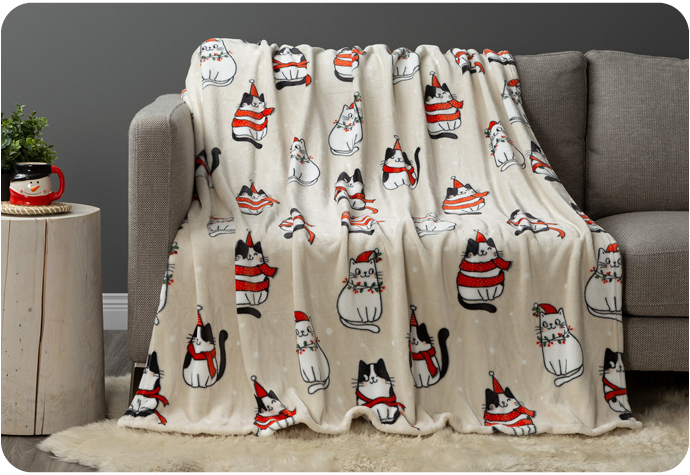 Our Christmas Cats Holiday Fleece Throw featuring an illustrative cat design on a beige backdrop.
