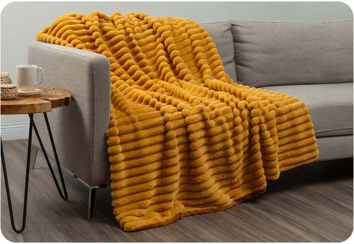 Our Ribbed Faur Fur Throw in Ochre features a rich mustard yellow chunky ribbed design.