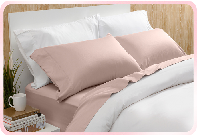 Our Bamboo Cotton Sheet Set in Blush is shown on a white bed.