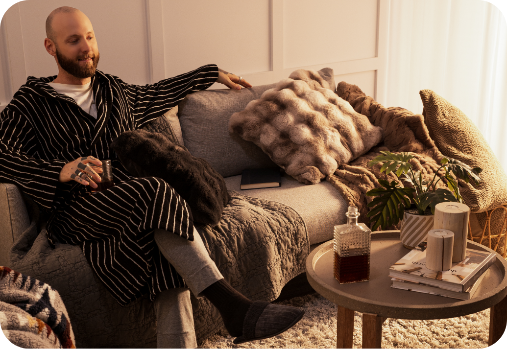 A man enjoying a hot drink while lounging at home.