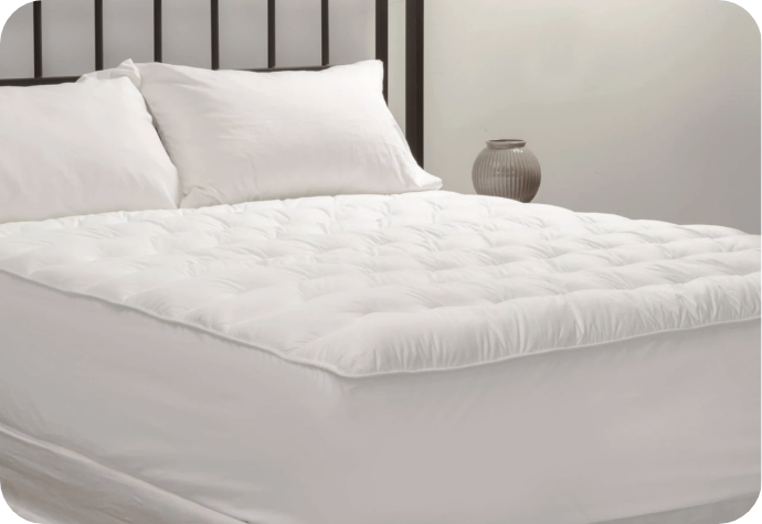 Quilted in protector comfort A mattress protector dressing a queen bed.