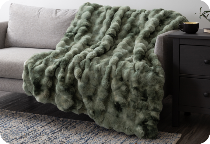 Our Bubbling Cauldron Bubble Throw Our Bubble Faux Fur Throw draped over a couch