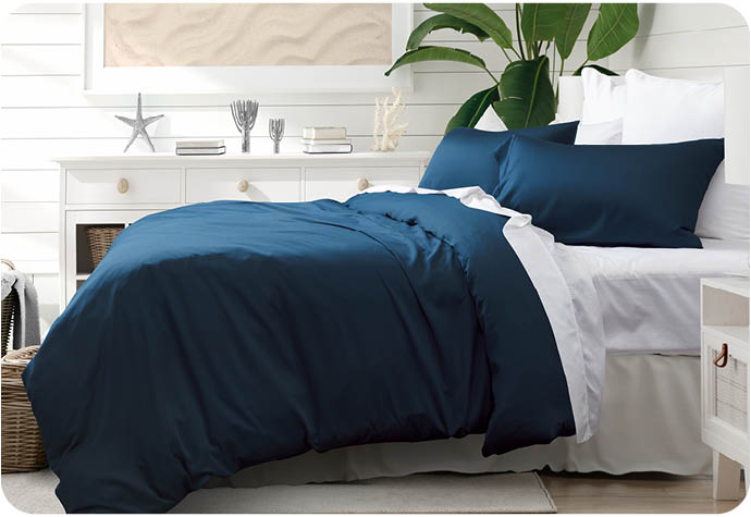 Our Seaport BeechBliss TENCEL™ Modal Duvet Cover styled on a white bed in a bedroom.