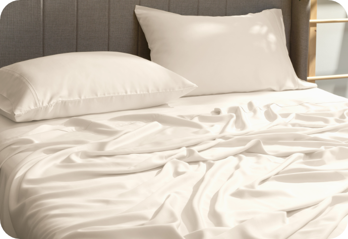 A beige set of sheets on a bed.