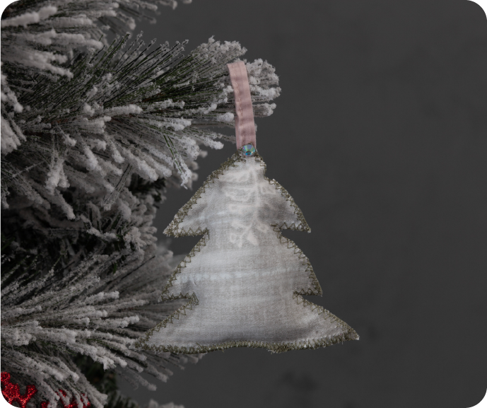 A close up shot of a DIY Fabric Scrap Holiday Decoration hanging on a Christmas tree. A close up shot of a DIY Fabric Scrap Holiday Decoration hanging on a Christmas tree.