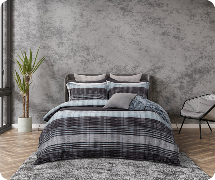 The Vilanova Duvet Cover from the Portugal Reserve Collection paired with a fluffy blue throw blanket dressing a queen bed in a modern bedroom. The Vilanova Duvet Cover from the Portugal Reserve Collection paired with a fluffy blue throw blanket dressing a queen bed in a modern bedroom.