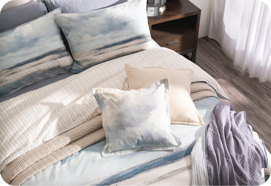 Our Windswept Duvet Cover Angled view of our Windswept Duvet Cover on a queen bed with accessories.