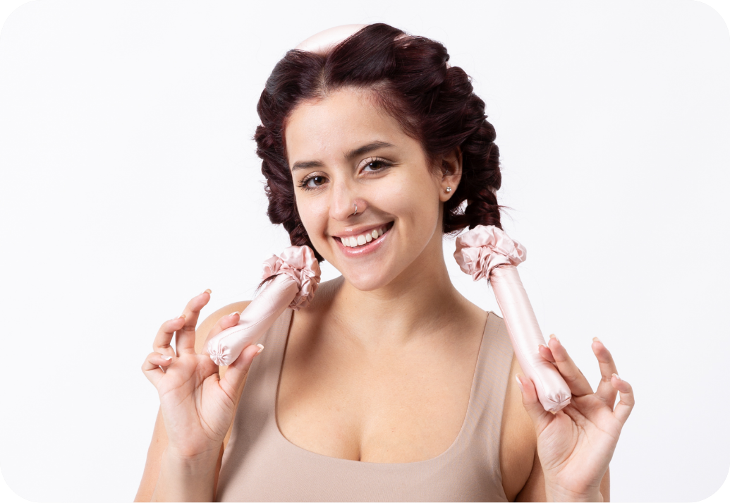 A woman using silk hair curlers. 